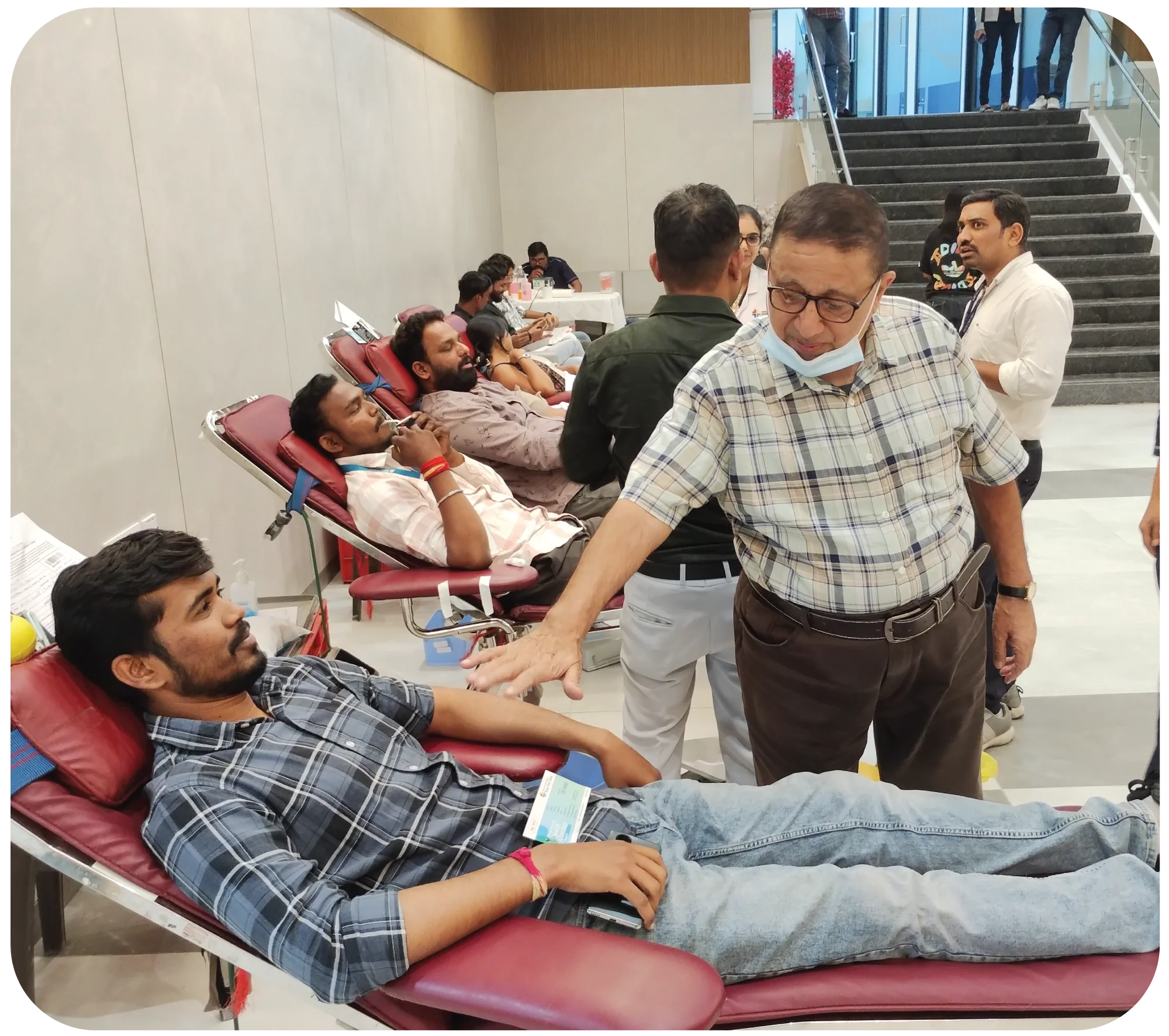 Multiple donors donating blood simultaneously in organized camp setup